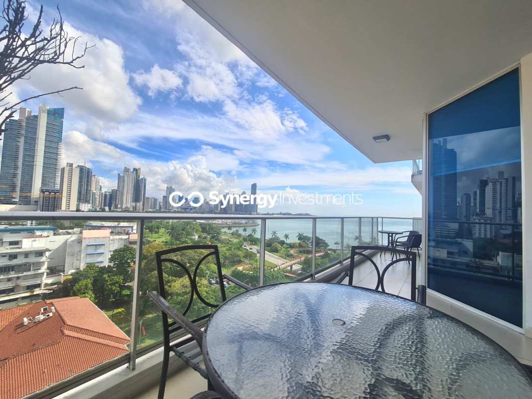 Balcony with glass railing overlooking ocean, city skyline and Avenida Balboa from PH BICSA condo Panama