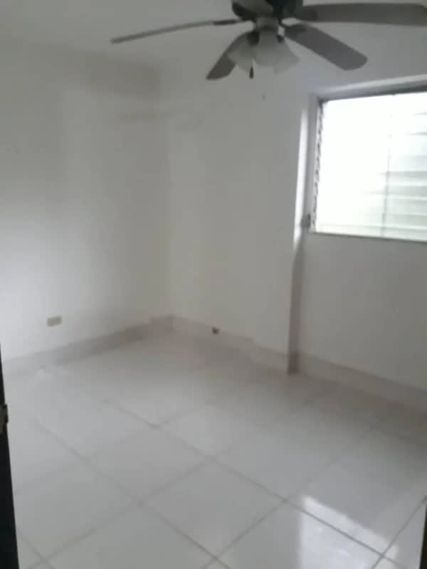 Functional bathroom with tiled walls, glass shower, grab bars in La Loceria apartment Bethania Panama