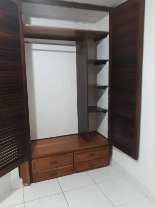 Laundry space with wash basin, concrete counter, washer setup in affordable apartment Bethania Panama