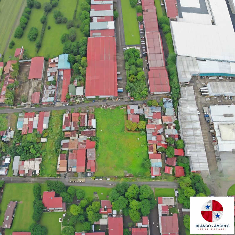 Large fenced commercial lot full city block in prime industrial zone near El Crisol metro station aerial view