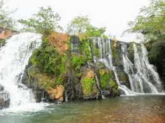 Rocky cascade waterfall amid verdant forest next to town in Veraguas Panama