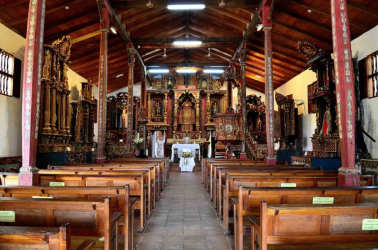 View inside colonial style church with altar and wood pews in San Francisco de la Montaña Panama