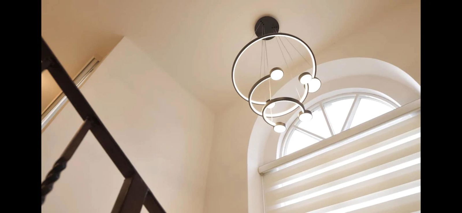 High ceiling interior with modern chandelier and arched windows at Albrook Gardens Clayton Panama