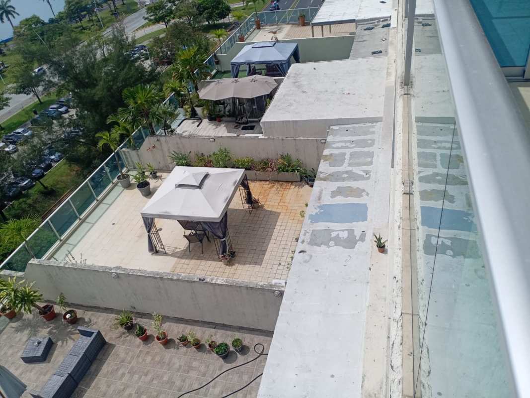 Open kitchen with granite tops, stainless appliances, tile floors, and breakfast bar in PH H2O Avenida Balboa Panama City