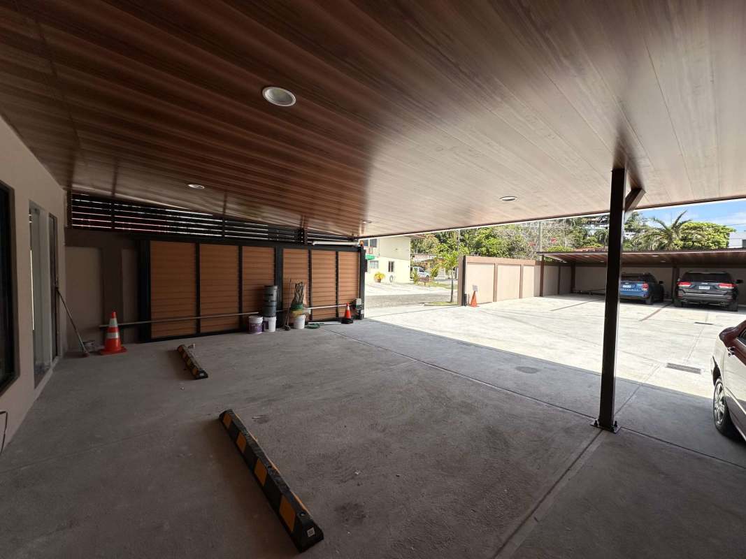 Entrance area to commercial building with parking space and security gate in Betania Panama City