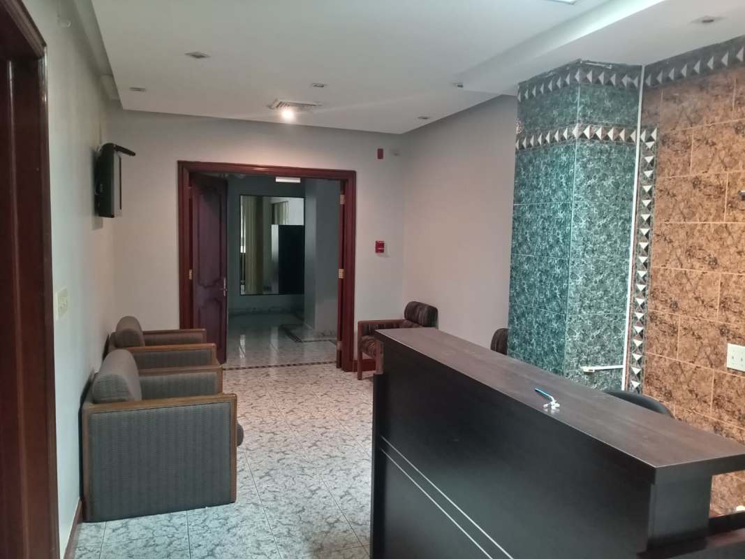 Luxurious executive office with wooden furnishings, display cabinets, and blue illuminated ceiling in PH BICSA Tower