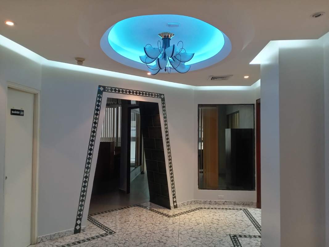 Hallway interior with geometric doorway, blue ceiling lights, patterned tile and modern finish in PH BICSA Tower
