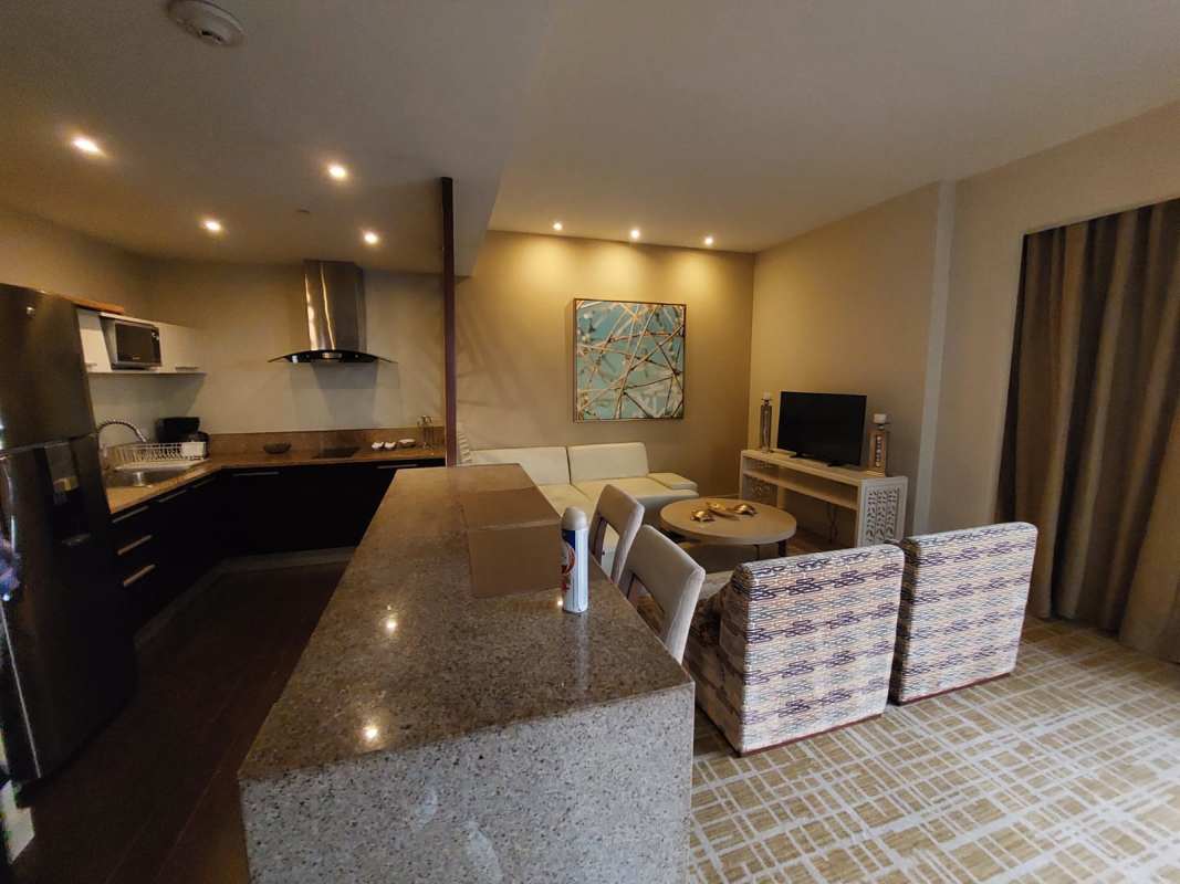 Contemporary open kitchen with granite breakfast bar and stainless appliances