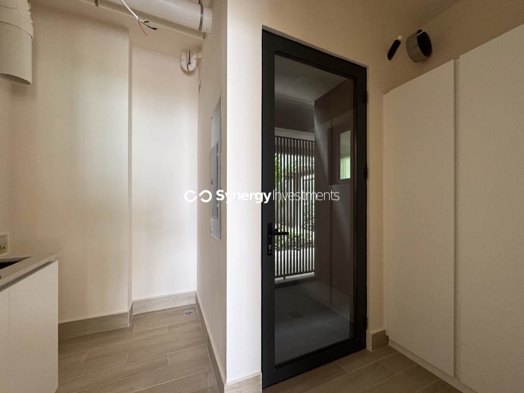 Open-concept kitchen with island and marble floors in PH Ocean Reef Islands Panama