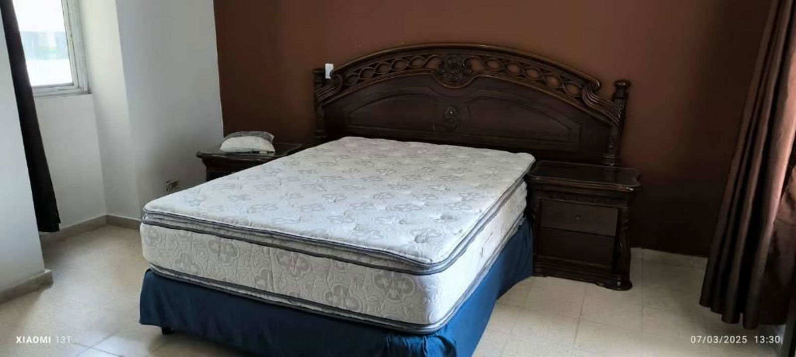 Traditional furnished bedroom with large window and classic wood furniture in PH Del Rey El Cangrejo Panama City