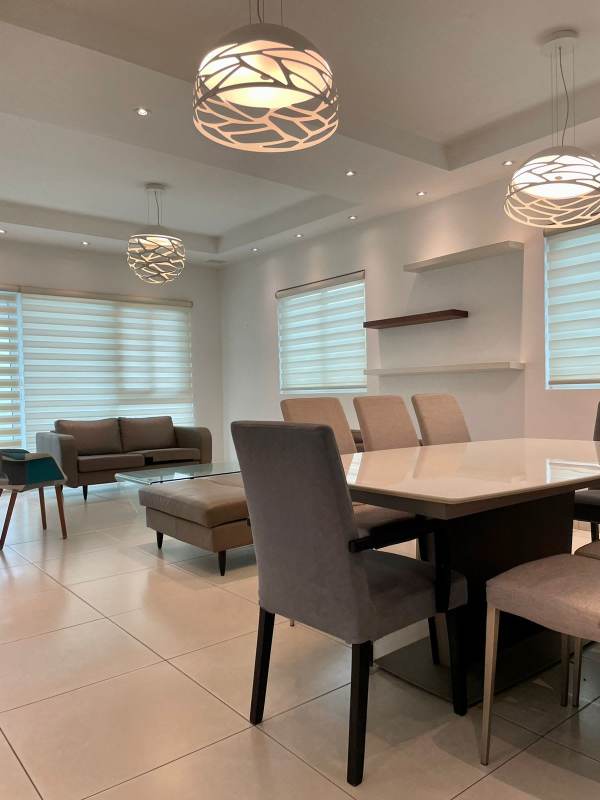 Minimalist living room with desk, grey sofa, ceiling fan at PH Horizonte II Condado del Rey