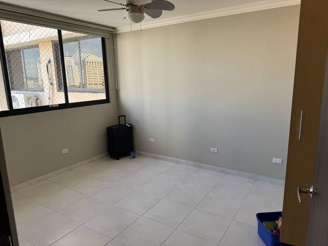 Bright bedroom with large window, tiled floor and safety mesh at PH La Fontana Obarrio Panama