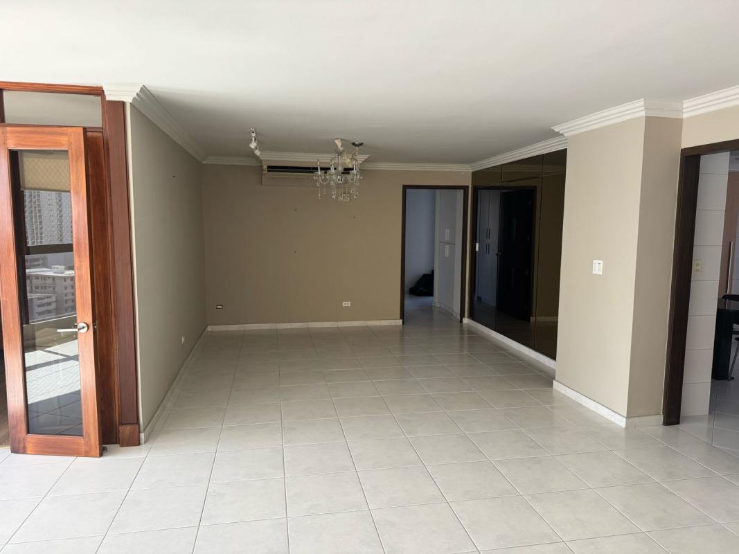 Spacious living room with wooden framed glass doors, mirrored wall PH La Fontana Obarrio Panama