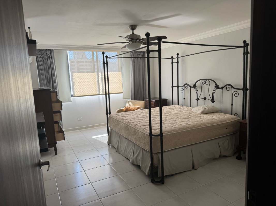 Bedroom with large window, ceiling fan, minimal furnishings at PH La Fontana Obarrio Panama City
