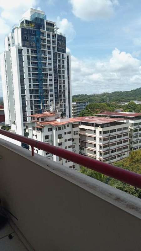Living room with large windows, balcony access and skyline views at PH El Cangrejo apartment