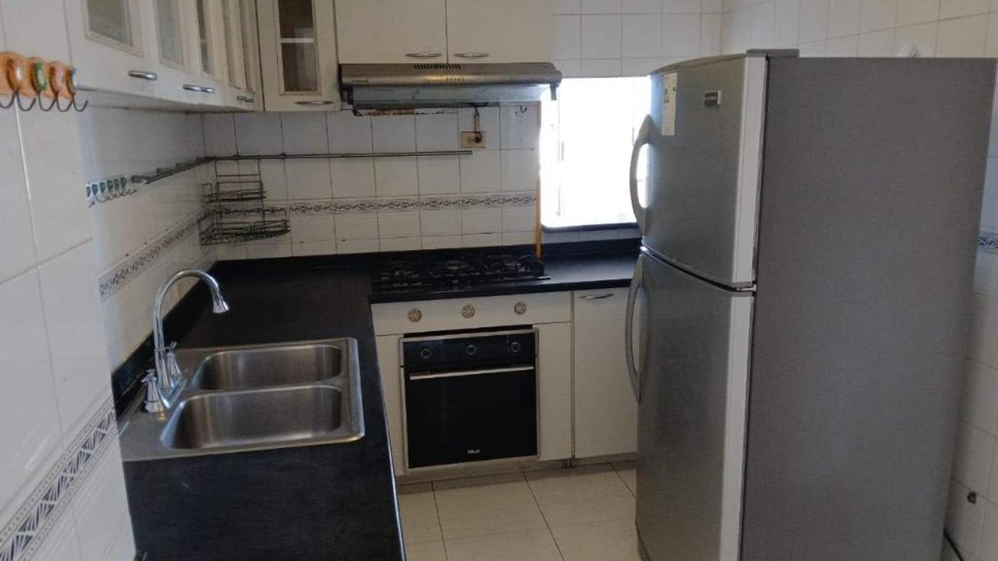 Modern kitchen with granite counters, gas stove, oven, refrigerator in PH El Cangrejo Panama