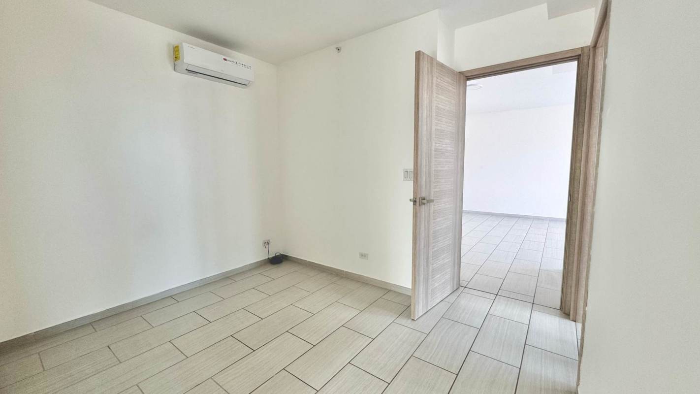 Minimalist bedroom with split AC, tile floors, white walls in PH The Towers San Francisco Panama City