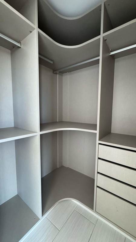 Spacious kitchen with light wood cabinets and tile backsplash PH The Towers Panama City