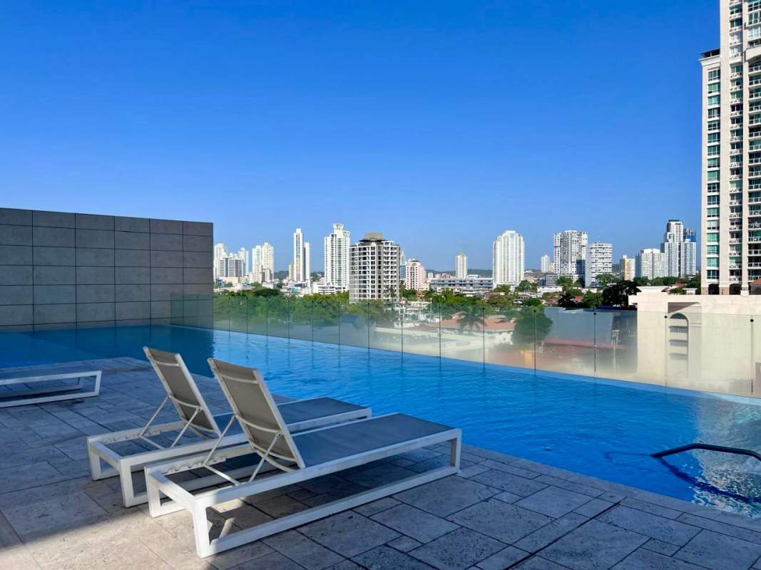 Infinity pool on rooftop with glass railings city skyline backdrop PH The Towers Panama