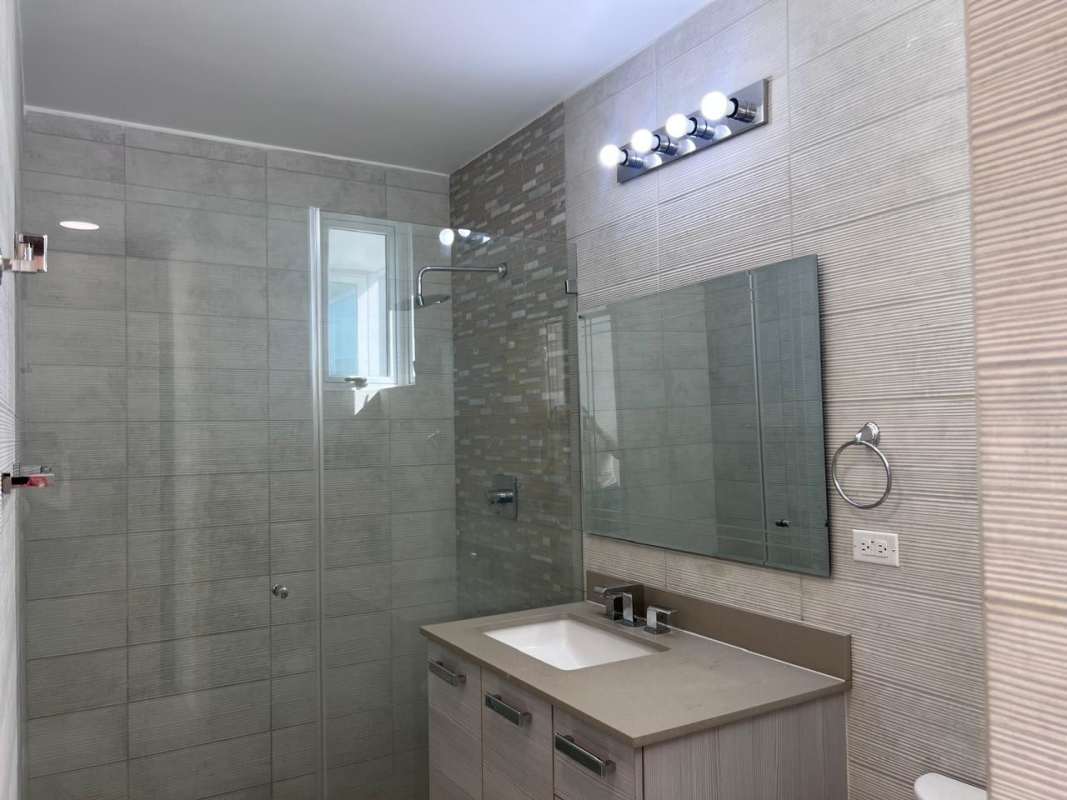 Tiled bathroom with glass shower enclosure modern vanity PH The Towers Panama City