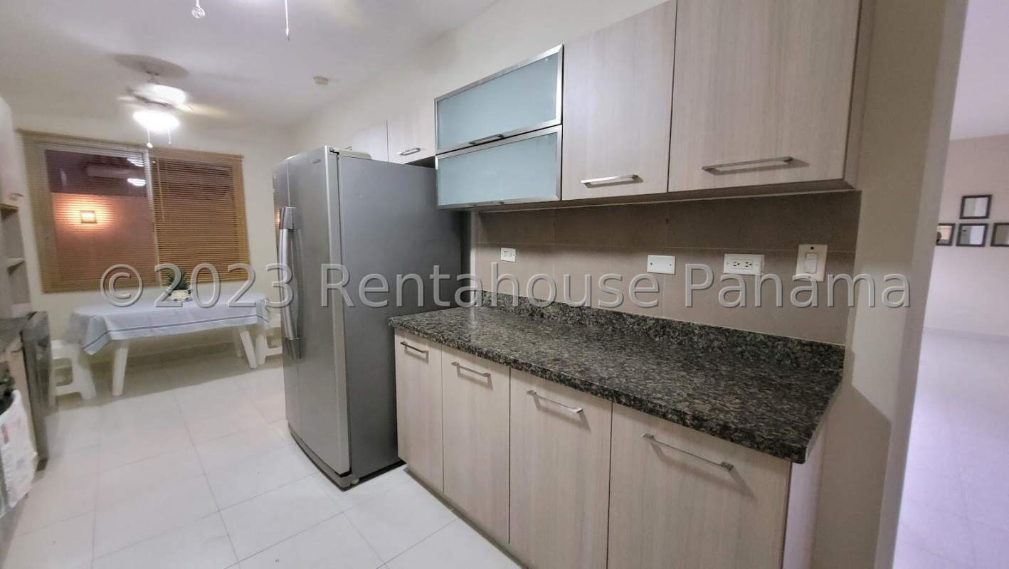 Kitchen with granite countertops, large window, dining setup in Quintas de Versalles Panama