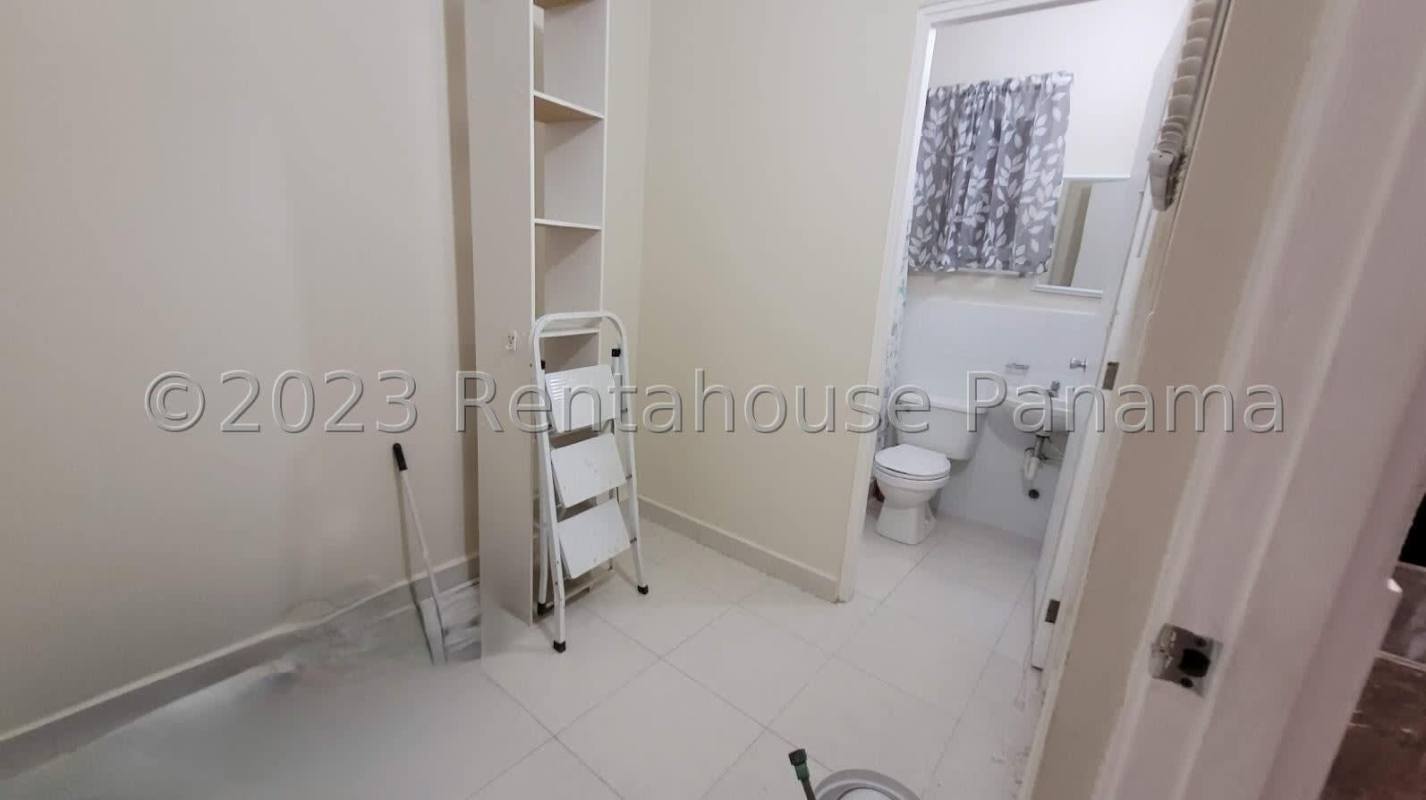 Covered porch with stone accents and potted plants at Quintas de Versalles Panama house