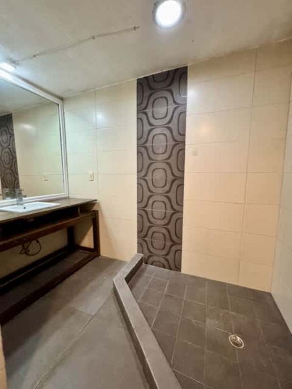 Galley kitchen with brown tile, granite countertop, appliances at Clayton rental apartment