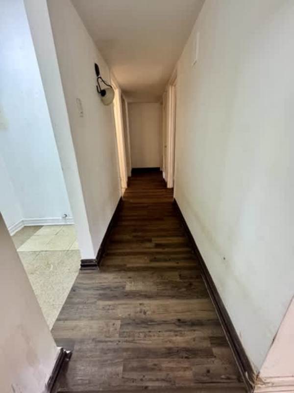 Ceramic tile hallway with wood accents connecting living area and bedrooms Clayton Panama