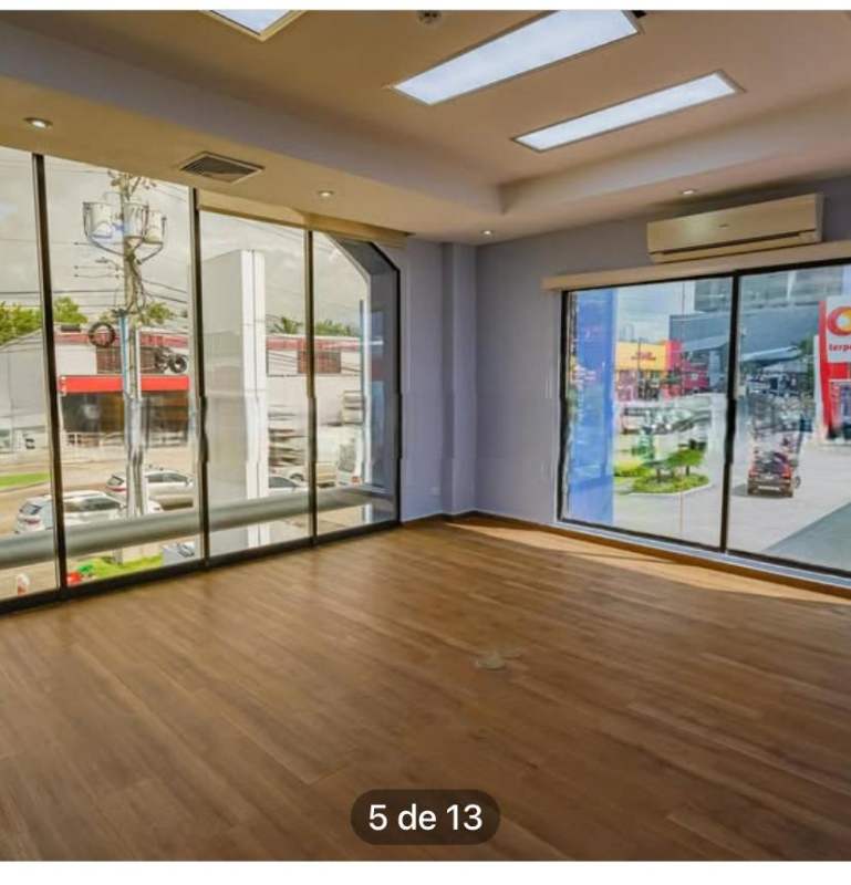 Empty corporate office space with large windows and wooden floor Costa del Este Panama for rent