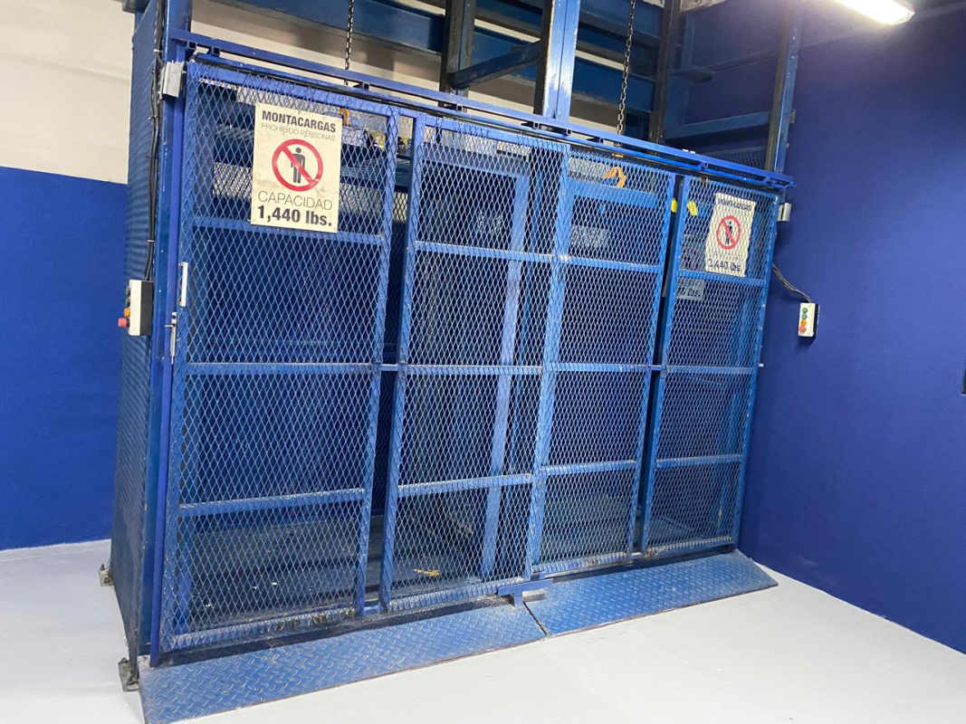 Freight elevator with metal mesh enclosure in warehouse Panama Costa del Este