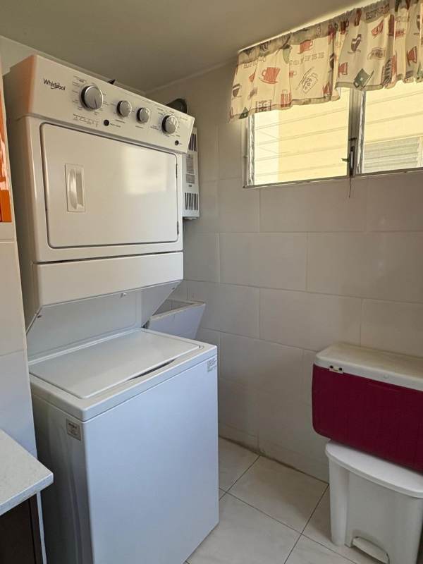 Laundry with stacked washer dryer and window in PH McGregor Hill Condado del Rey Panama