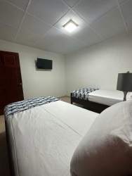 Cozy bedroom two beds and mounted TV in Valle de la Luna Panama house