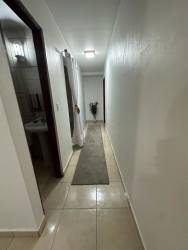 Modern bedroom with mounted TV and closet in family house Chiriquí