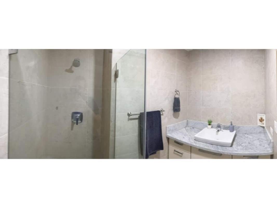 Modern bathroom with marble countertop and glass shower PH Park City Obarrio Panama