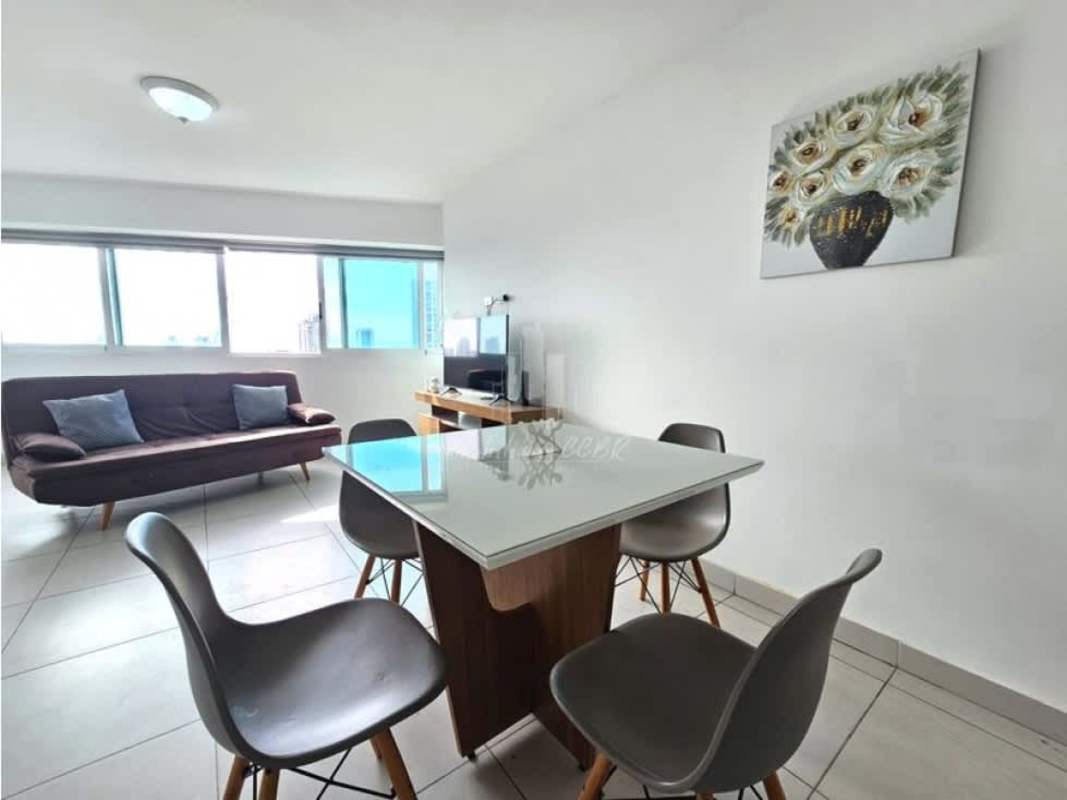 Open plan living and dining area with balcony access and city views at PH Tee One San Francisco