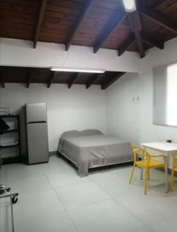 Minimalist studio apartment kitchenette wood cabinets Panama City