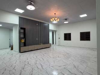 Large open living room with marble-effect tiles, partition wall, and natural light San Antonio Las Lomas David