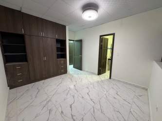 Covered patio with decorative columns and gated entry illuminated at night in Las Lomas David Panama