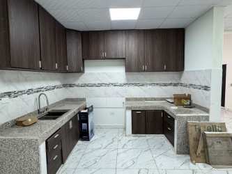 Renovated kitchen with granite counters, dark cabinets, marble tile floor, and backsplash San Antonio Las Lomas
