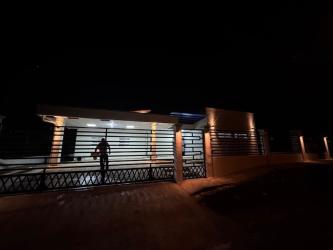 Gated modern house with fence and exterior lighting at night San Antonio Las Lomas David Panama