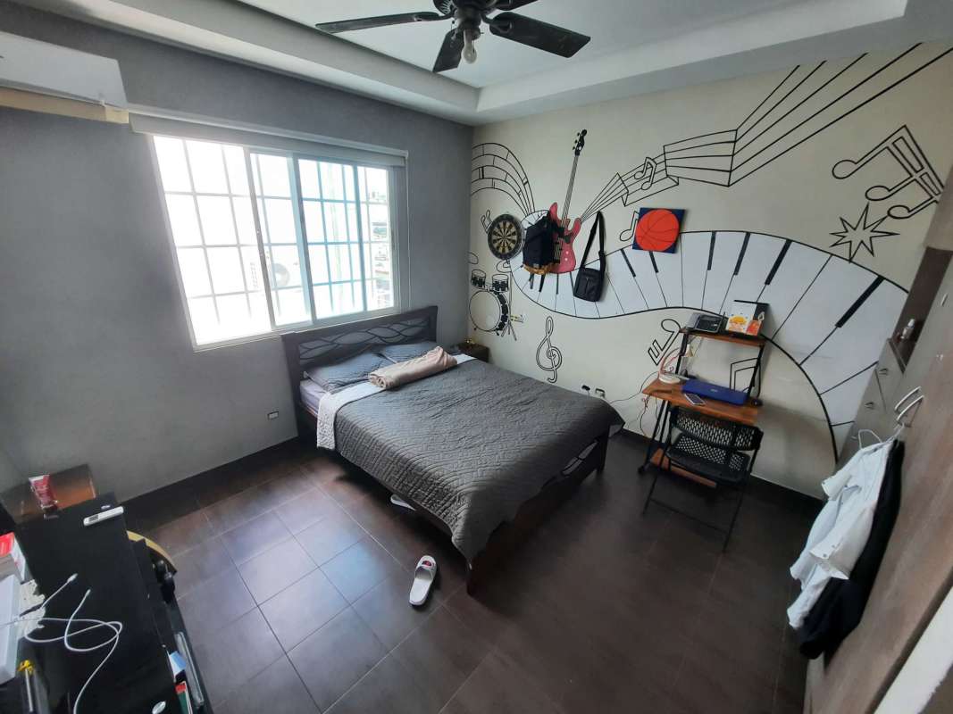 Bedroom with built-in desk, large window, ceiling fan and A/C at Altos de Panamá residence