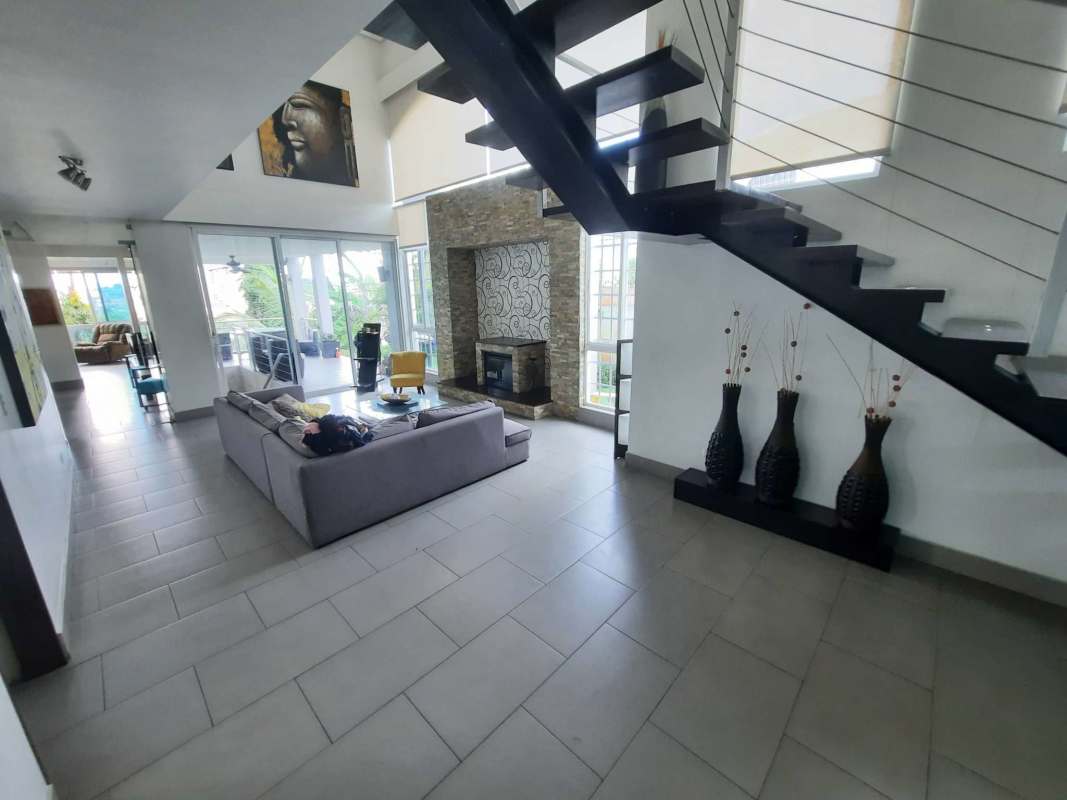 Bedroom with large window, built-in closet, ceiling fan, modern décor and balcony access in Altos de Panamá