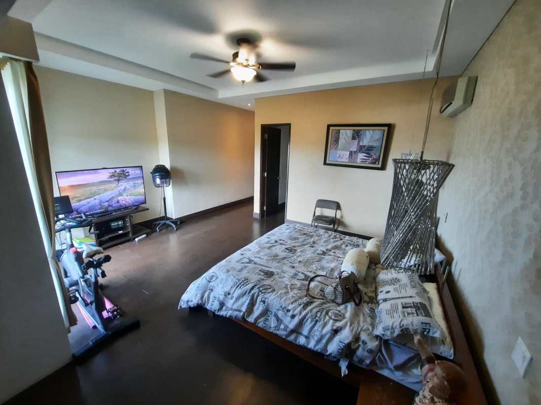 Modern bathroom glass enclosed shower bathtub double sinks wooden accents in Altos de Panama luxury home