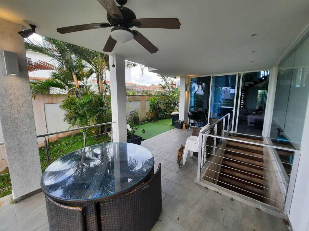 Covered terrace with outdoor dining ceiling fans and garden Altos de Panama gated home