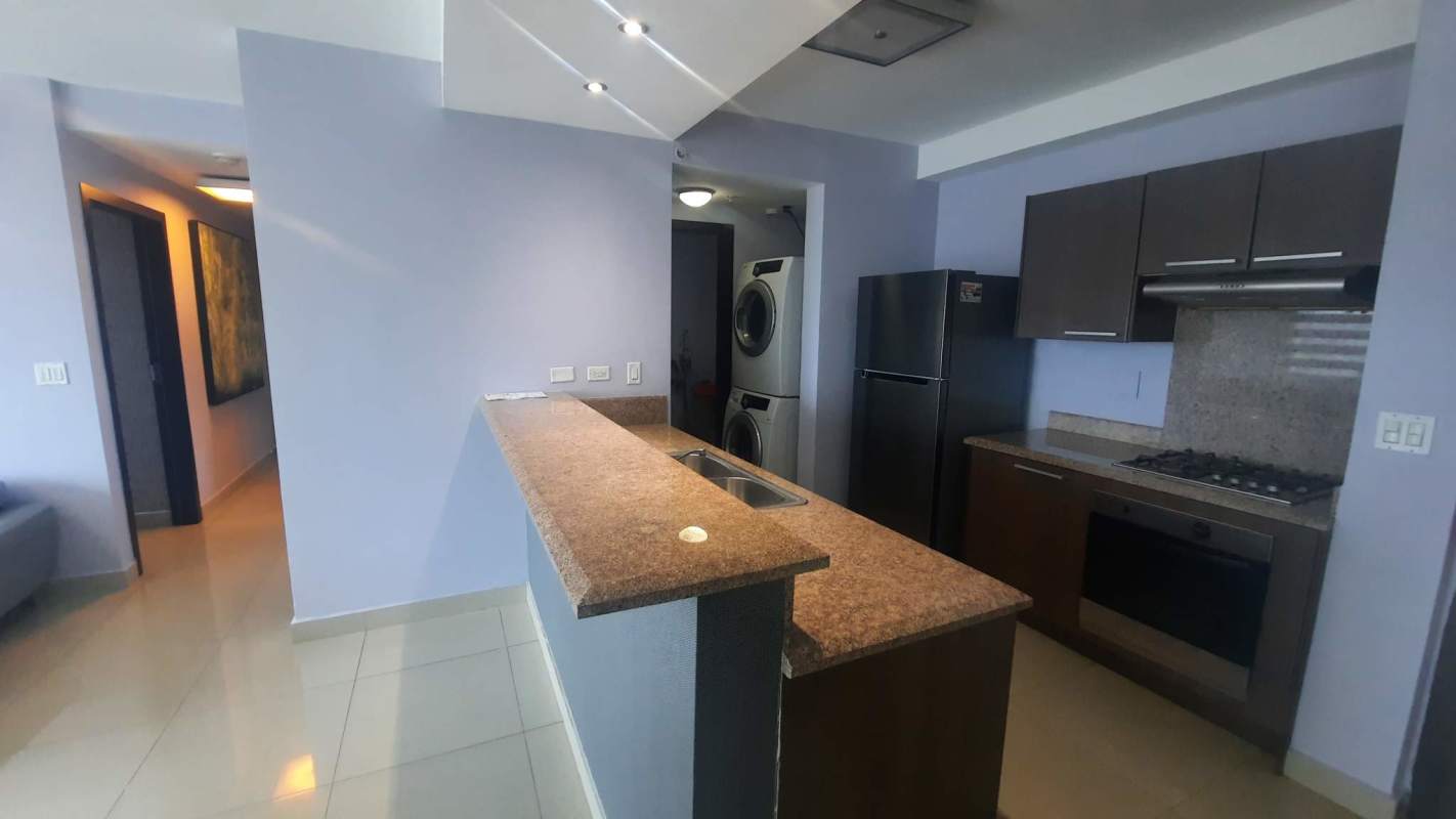 Modern kitchen with granite countertops and laundry appliances Costa del Este PH Costa del Mar