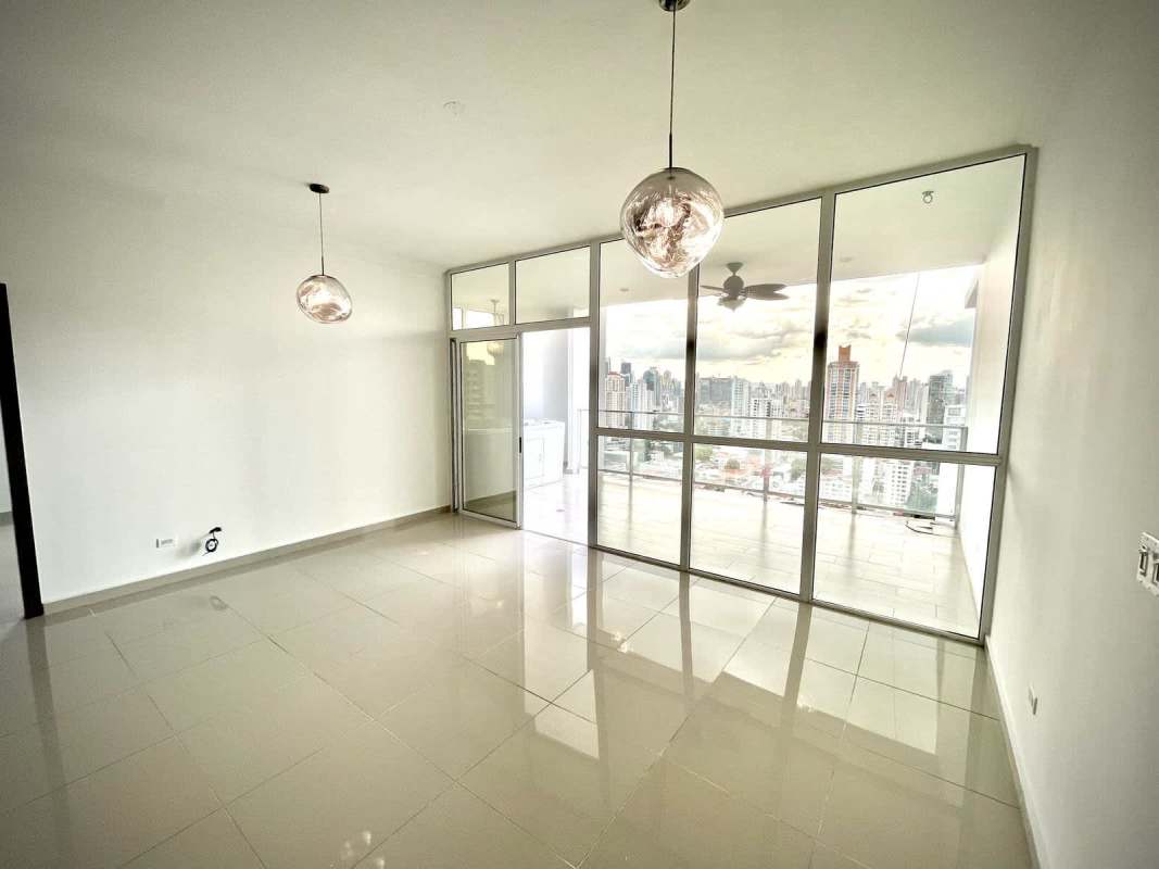 Modern living area with floor-to-ceiling windows, access to balcony PH Quadrat San Francisco Panama City
