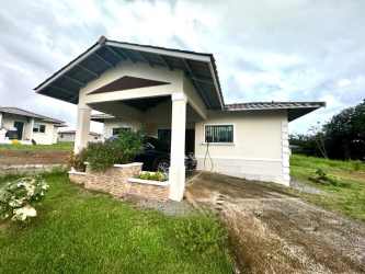 Exterior of single-story house with covered parking and garden in David Panama