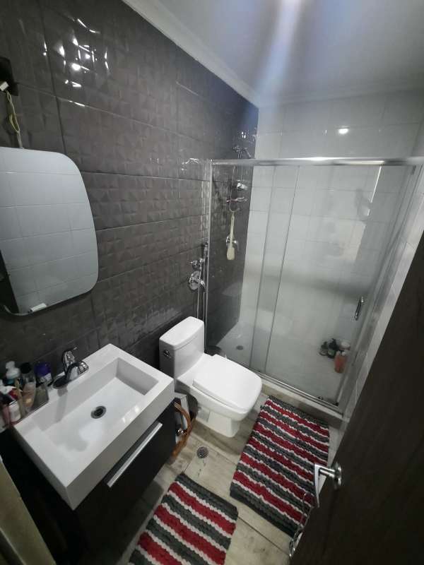 Modern bathroom with glass shower enclosure, stylish tiling, vanity sink in PH Carrasquilla Panama