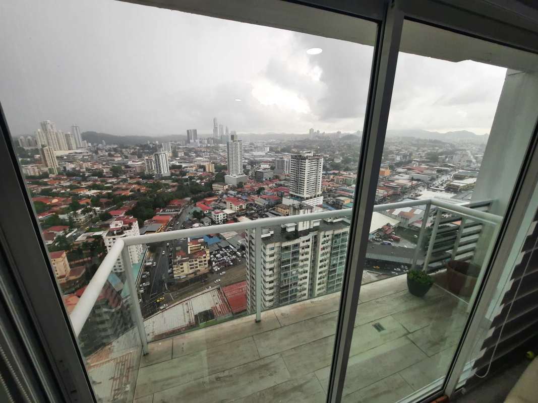 Bedroom featuring wardrobe, large window with city scenery PH Carrasquilla Panama