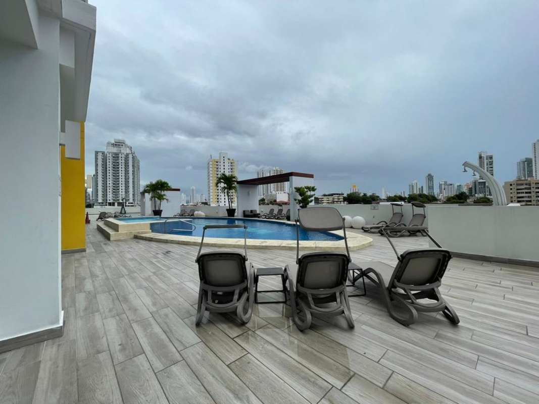 Rooftop swimming pool with lounge chairs and panoramic city views in PH Carrasquilla Panama